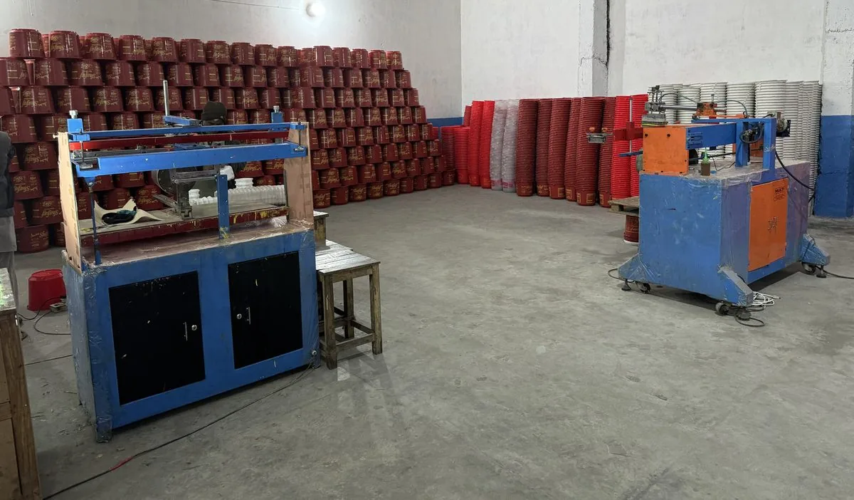 In-house screen printing machines and printed red buckets at the Majid Industries factory